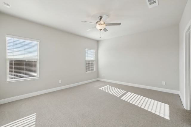 spare room with ceiling fan and carpet flooring