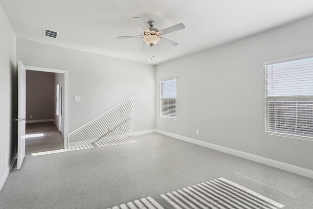 spare room with ceiling fan and carpet floors