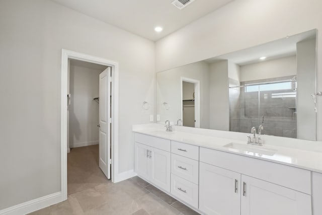 bathroom featuring an enclosed shower, vanity, and tile patterned flooring