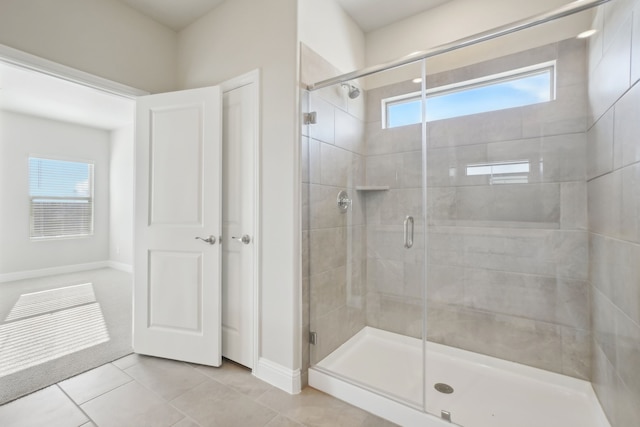 bathroom with walk in shower and tile patterned floors