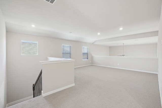 unfurnished room featuring light carpet