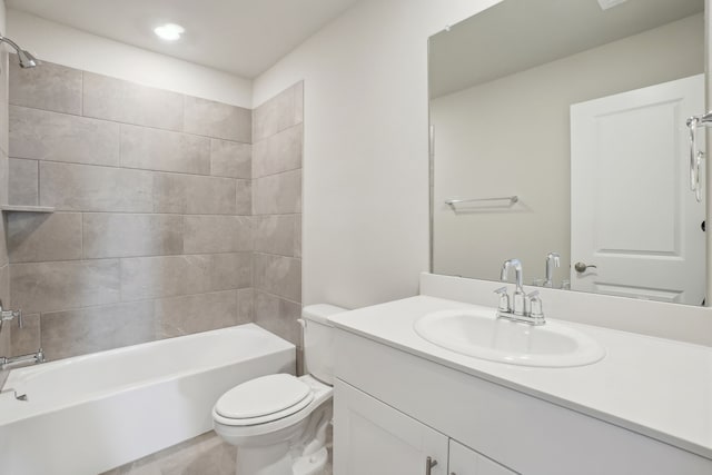 full bathroom featuring tiled shower / bath combo, vanity, and toilet