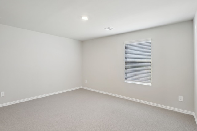 unfurnished room featuring carpet