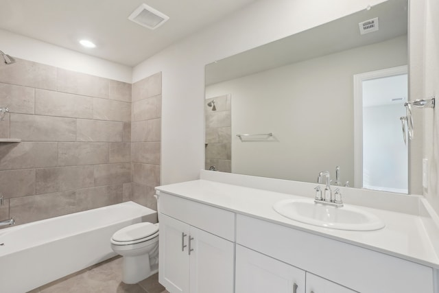 full bathroom featuring toilet, tiled shower / bath combo, tile patterned flooring, and vanity