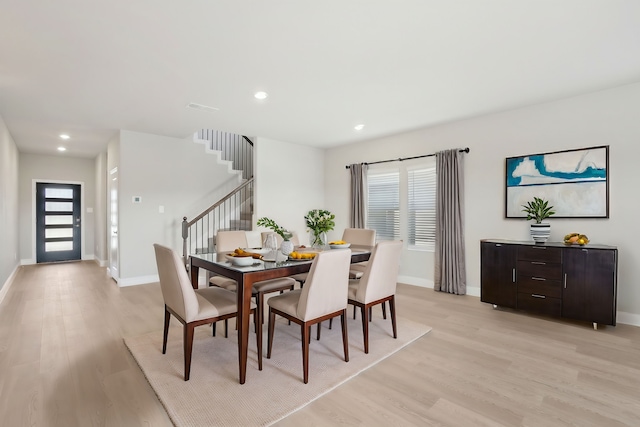 dining room featuring a wealth of natural light and light hardwood / wood-style flooring