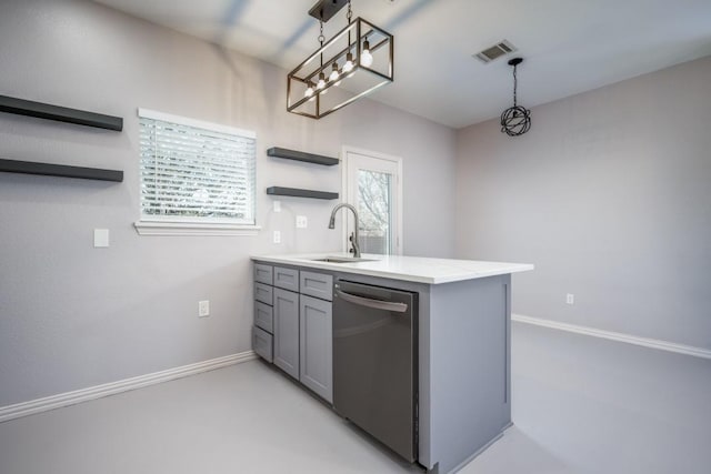 kitchen with kitchen peninsula, stainless steel dishwasher, sink, gray cabinets, and hanging light fixtures