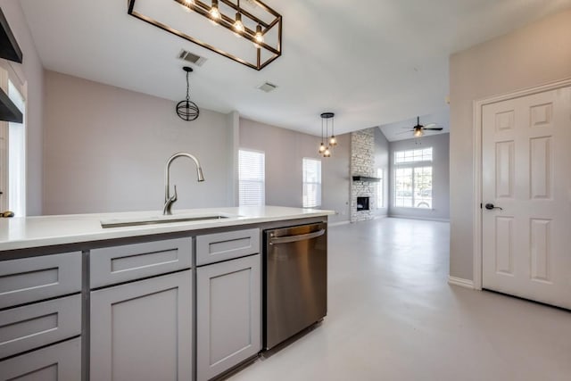 kitchen featuring dishwasher, sink, ceiling fan, gray cabinets, and a fireplace