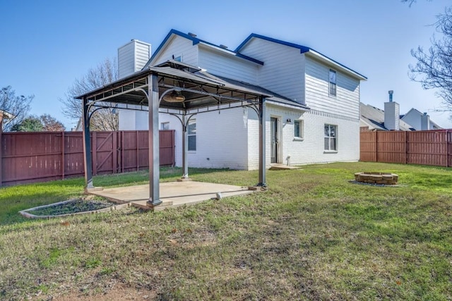 view of yard featuring a gazebo, a patio area, and a fire pit