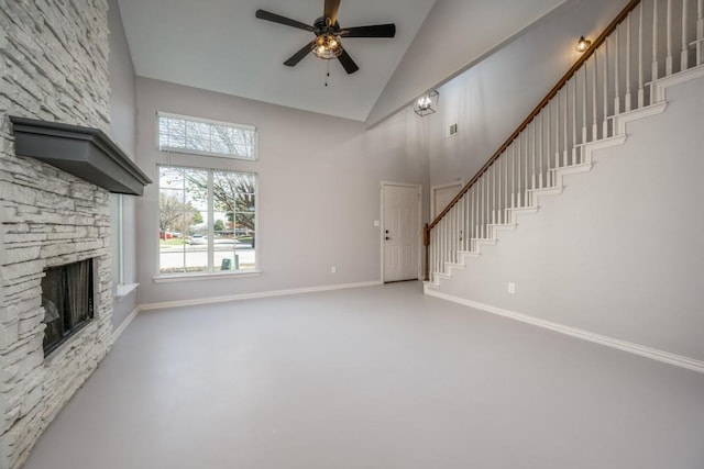 unfurnished living room featuring ceiling fan, concrete flooring, a fireplace, and high vaulted ceiling