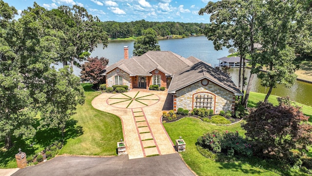 view of front of home with a front yard and a water view