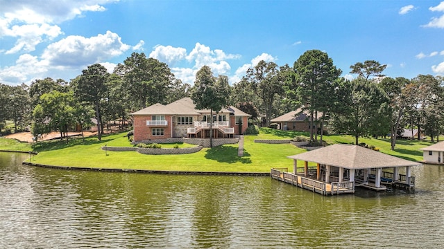 view of dock with a water view and a lawn