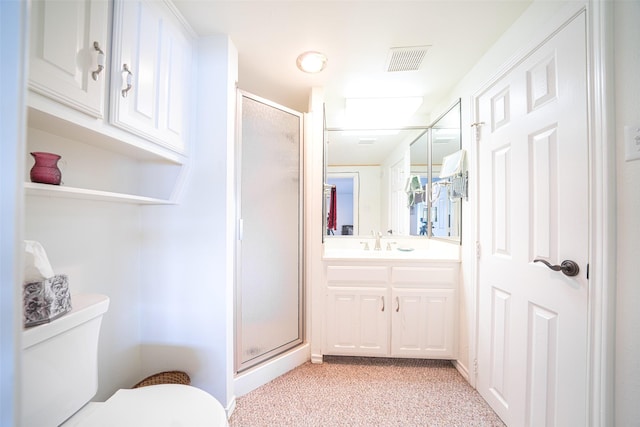 bathroom featuring vanity, toilet, and an enclosed shower