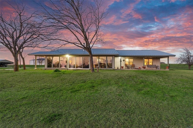 7901 County Road 222, Hico, TX 76457 - back house at dusk featuring a patio and a lawn