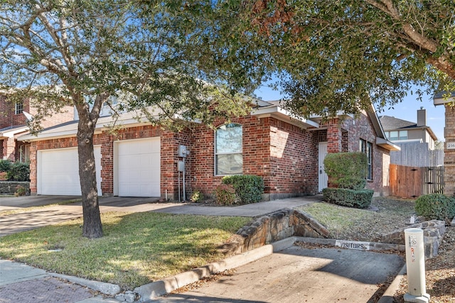 view of front of property with driveway, a front yard, and brick siding