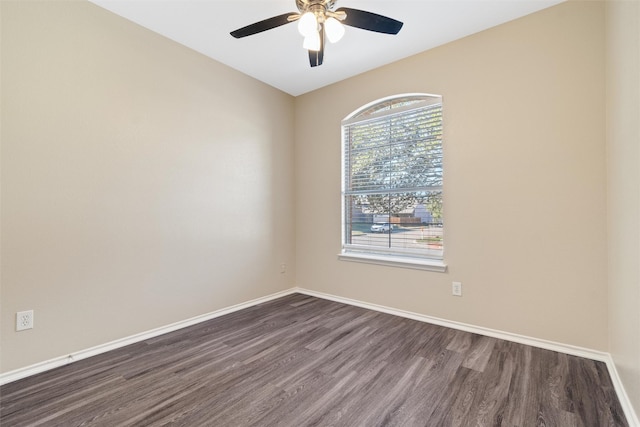 spare room featuring dark hardwood / wood-style floors and ceiling fan