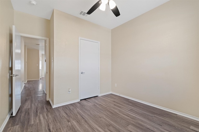 unfurnished bedroom with dark hardwood / wood-style floors and ceiling fan