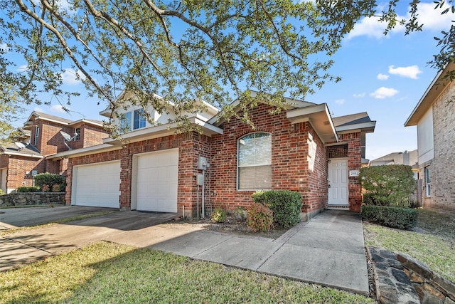 view of front of house with a garage, brick siding, and driveway