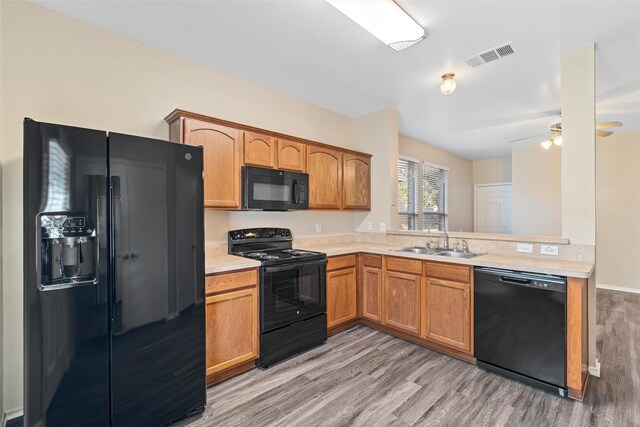 kitchen featuring black electric range oven, sink, and dark hardwood / wood-style floors