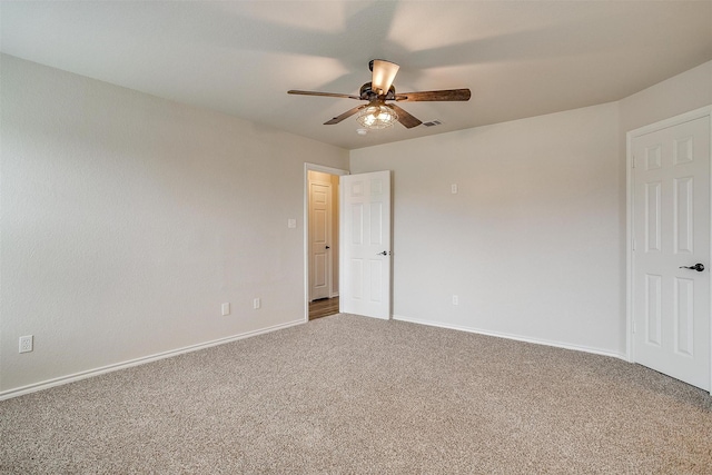 carpeted spare room with ceiling fan