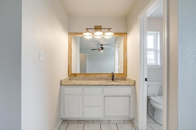 bathroom with ceiling fan, vanity, and toilet