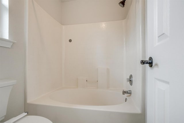 bathroom with toilet and shower / washtub combination