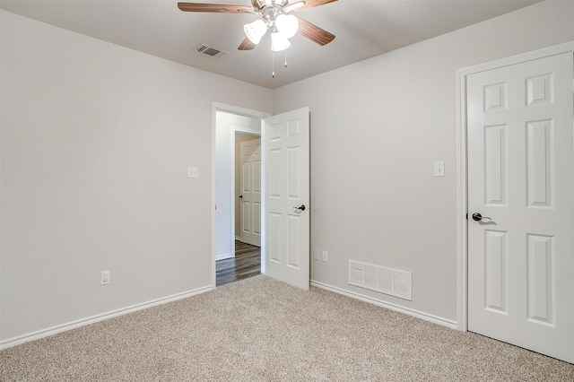 unfurnished bedroom with ceiling fan and carpet floors