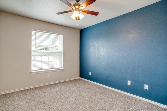 unfurnished room with ceiling fan and carpet floors