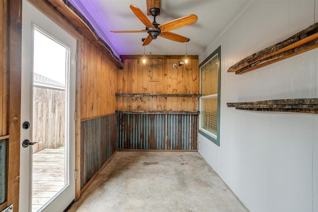 bar featuring ceiling fan and wooden walls