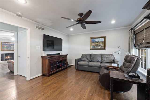 living room with ceiling fan, dark wood-type flooring, and ornamental molding