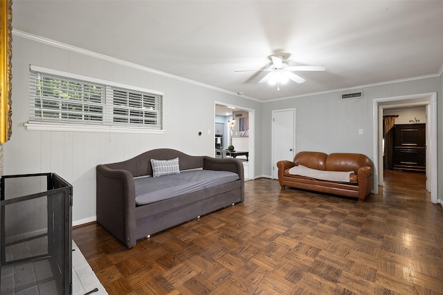 living room with dark parquet flooring, ceiling fan, and crown molding