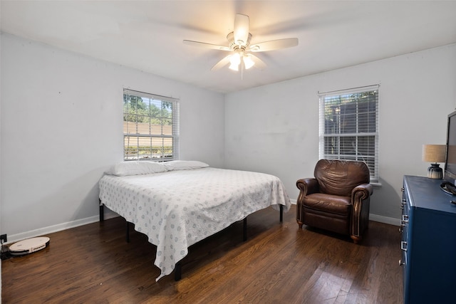 bedroom with ceiling fan and dark hardwood / wood-style floors