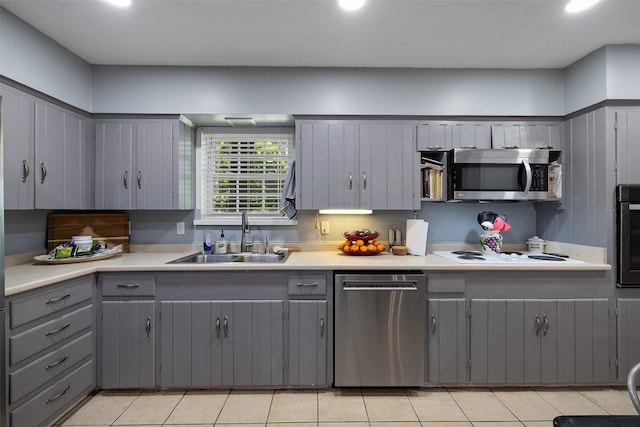 kitchen featuring gray cabinets, light tile patterned floors, sink, and appliances with stainless steel finishes