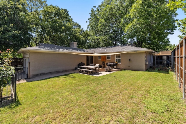 rear view of property featuring a patio area and a yard