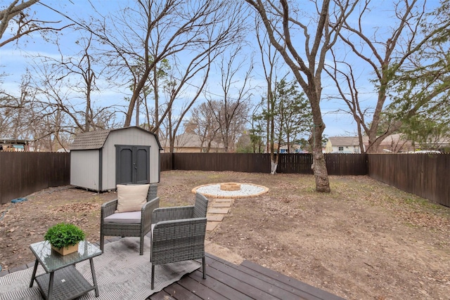 wooden deck with a fire pit and a storage shed