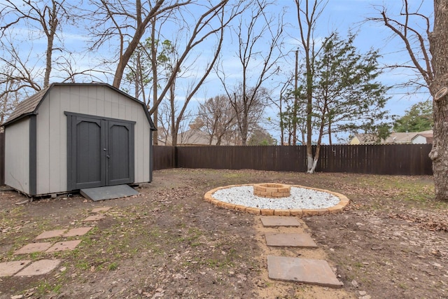 view of yard featuring a fire pit and a storage shed