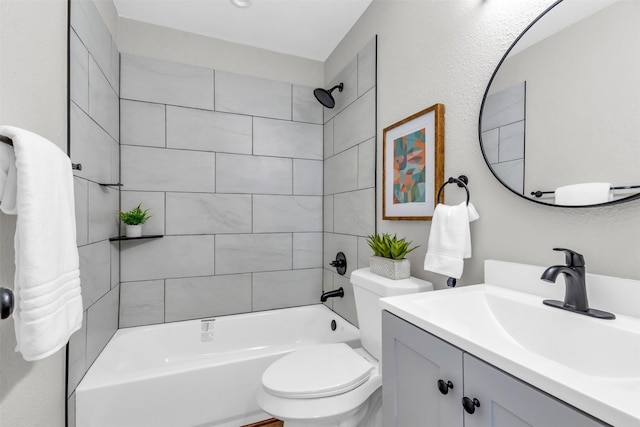 full bathroom featuring tiled shower / bath combo, toilet, and vanity