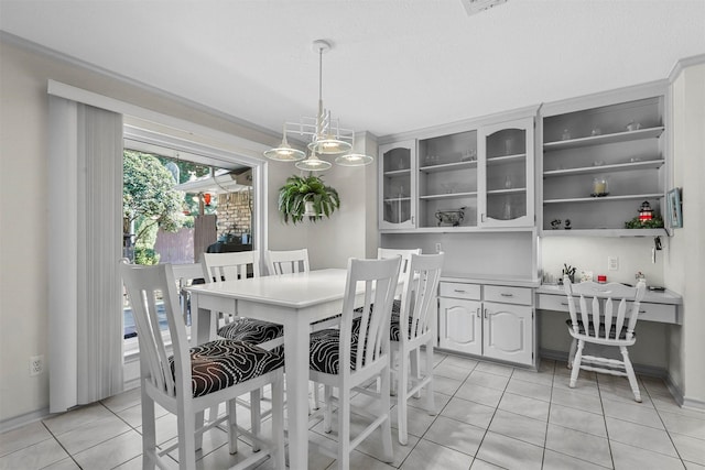 tiled dining area featuring a notable chandelier