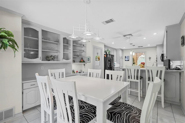 tiled dining room featuring ceiling fan