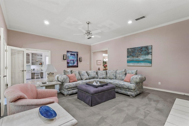 carpeted living room with a textured ceiling, ceiling fan, and crown molding