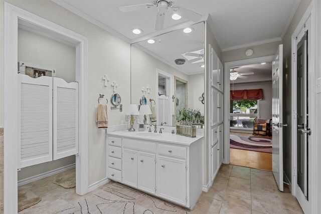 bathroom with tile patterned floors, ceiling fan, vanity, and ornamental molding