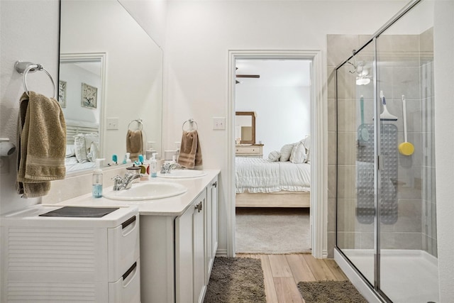 bathroom featuring hardwood / wood-style flooring, vanity, and walk in shower