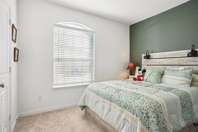 bedroom with carpet floors and multiple windows