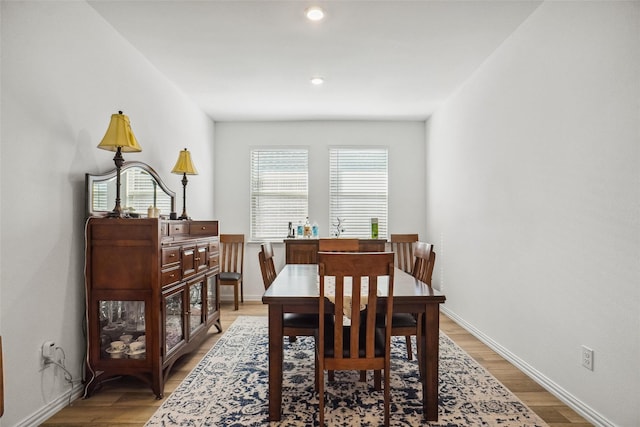 dining room featuring hardwood / wood-style floors and a healthy amount of sunlight