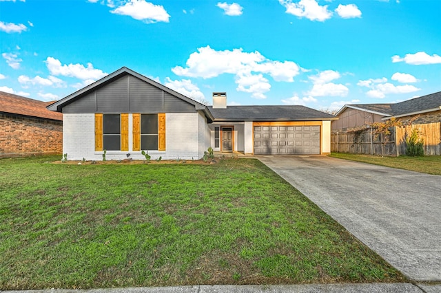 view of front of property with a front lawn and a garage