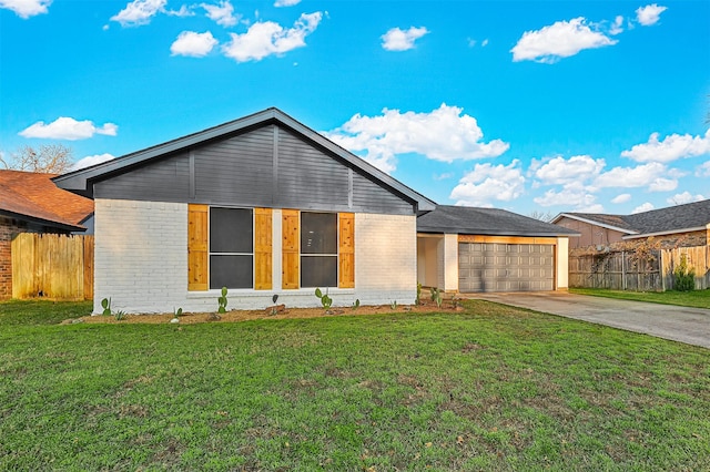 view of front of home with a front lawn and a garage