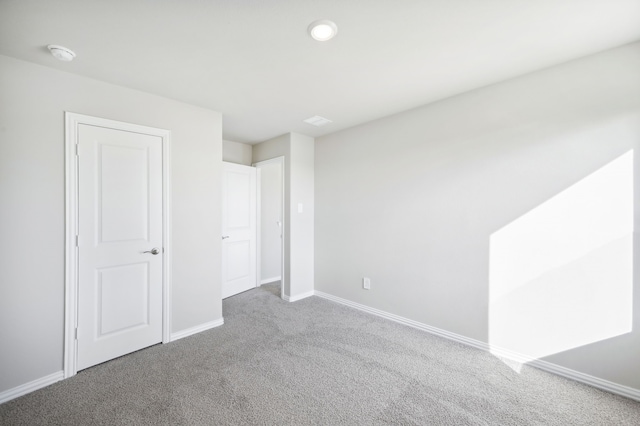 unfurnished bedroom with carpet floors and baseboards