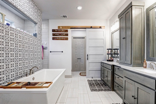 bathroom with vanity and a tub