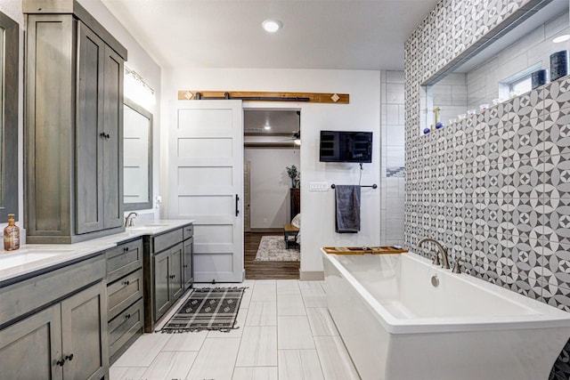 bathroom with a tub to relax in and vanity