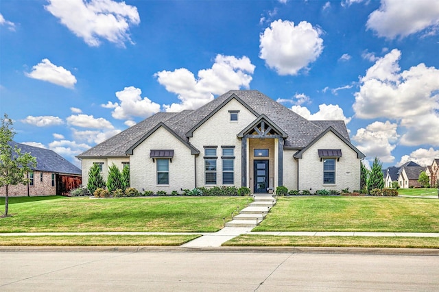 view of front of home with brick siding and a front yard