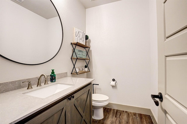 bathroom featuring hardwood / wood-style floors, vanity, and toilet